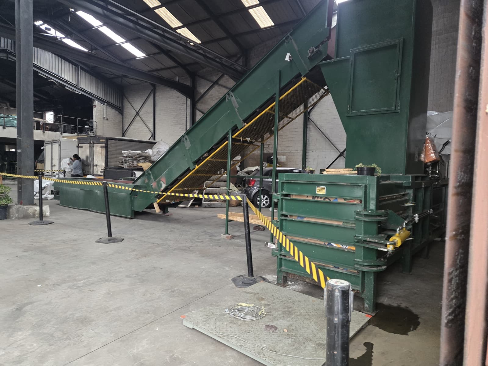 WasteGo Green's green baler press and infeed conveyor inside the Milnerton processing facility