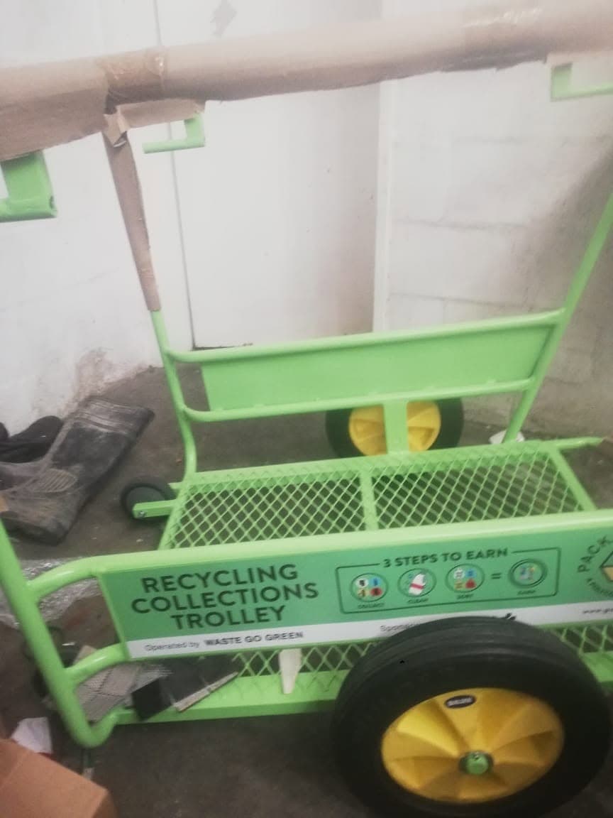 WasteGo Green branded green ‘Recycling Collections Trolley’ showing the 3 steps to earn: collect, clean, sort